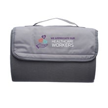 Healthcare Workers Roll Up Picnic Blanket