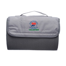 Volunteers Roll Up Picnic Blanket